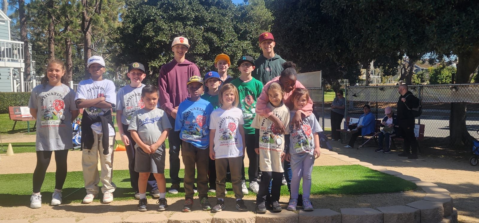 The full Youth Golf Clinic group in Motivating All Cultures clinic shirts at Bixby Village Golf Course.