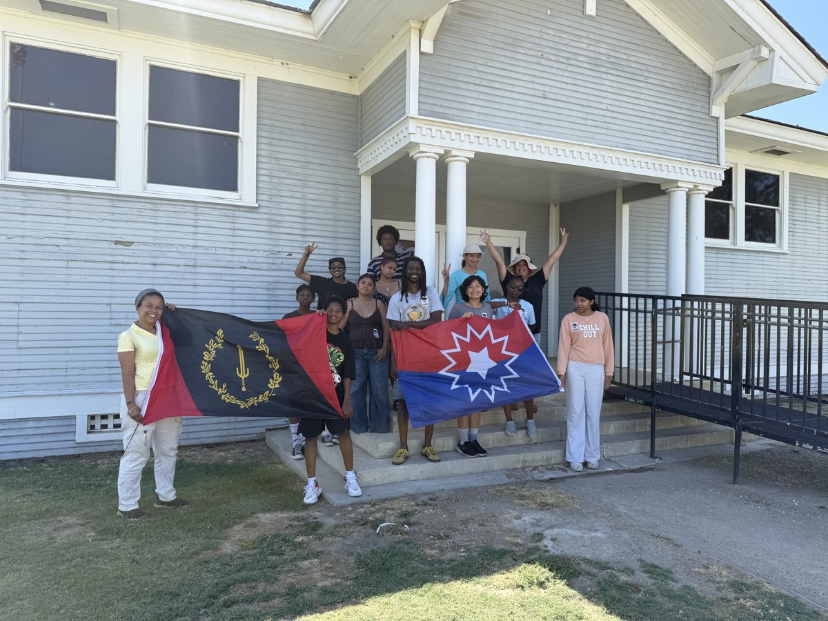 Students holding the Juneteenth and Pan-African flags at Allensworth State Park